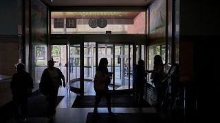 People walk inside a hospital during a nationwide power outage in Pamplona, northern Spain, Monday, April 28, 2025.