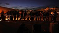People gather outside Atocha train station during a major power outage in Madrid, Monday, April 28, 2025. 