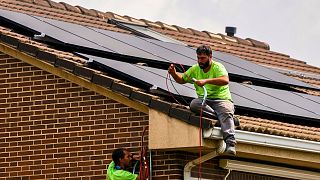 Workers install solar planers on the roof of a house in Rivas Vaciamadrid, Spain, September 2022.