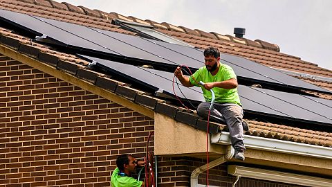 Workers install solar planers on the roof of a house in Rivas Vaciamadrid, Spain, September 2022.