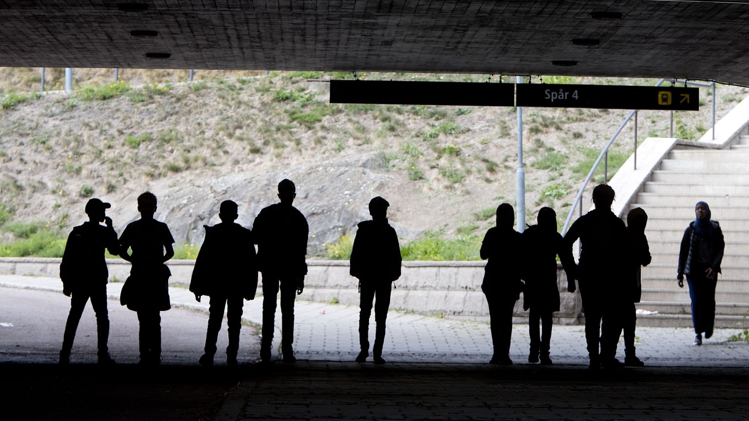 Migrant pupils walk under a railway bridge in Flen west of Stockholm, 30 August, 2018