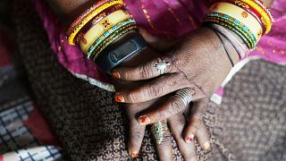 A wristwatch-style health monitor to study how heat affects vulnerable communities is worn by Shantaben Vanzara at her house in Ahmedabad, India.