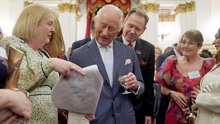 Britain's King Charles III speaks to guests during a reception in Buckingham Palace in London on April 30, 2025.