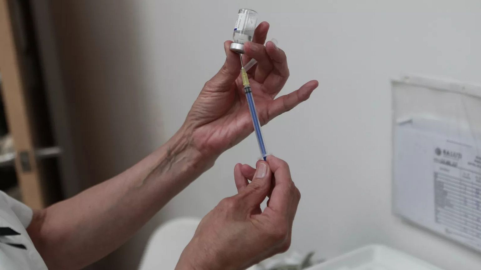 A health worker prepares a dose of the measles vaccine in April 2025.