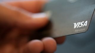 A Visa logo is displayed on a credit card in New Orleans. 11 August 2019.
