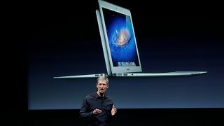 Apple CEO Tim Cook with Air during announcement at Apple headquarters in Cupertino, Calif., Tuesday, Oct. 4, 2011.