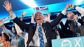 Reform UK leader Nigel Farage with his party's candidates onstage during a campaign event at Stafford Showground, 30 April 2025