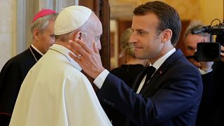 FILE: Il presidente francese Emmanuel Macron stringe la mano e va ad abbracciare Papa Francesco al termine della loro udienza privata, in Vaticano, 26 giugno 2018