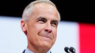 Canadian Prime Minister Mark Carney speaks to supporters on stage at his campaign headquarters after the Liberal Party won the Canadian election in Ottawa, Ontario, Tuesday