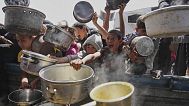 Palestinian children struggle to get donated food at a community kitchen in Khan Younis, Gaza Strip, Saturday, May 3, 2025.