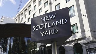 A sign stands in front of the New Scotland Yard, the headquarters of the London Metropolitan Police, in London, Monday, Sept. 25, 2023. 