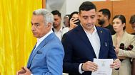 Calin Georgescu stands next to presidential candidate George Simion as they cast their votes in the first round of the presidential election redo in Mogosoaia, 4 May 2025