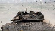 FILE: Israeli soldiers drive a tank on the border with the Gaza Strip, in southern Israel, 13 February 2024