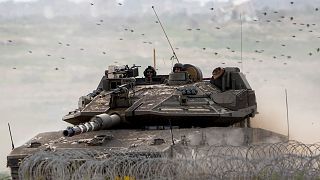 FILE: Israeli soldiers drive a tank on the border with the Gaza Strip, in southern Israel, 13 February 2024