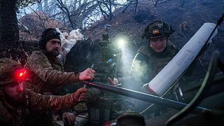 Ukrainian servicemen load ammunition into a M777 howitzer before firing towards Russian positions in the Donetsk region, 26 January, 2025