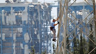 An electricity worker climbs on an electricity pylon next to the Mari power station, 12 July, 2011