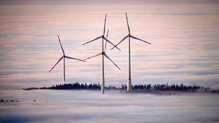 Wind turbines are surrounded by fog in the Taunus region near Frankfurt, Germany, November 2024.