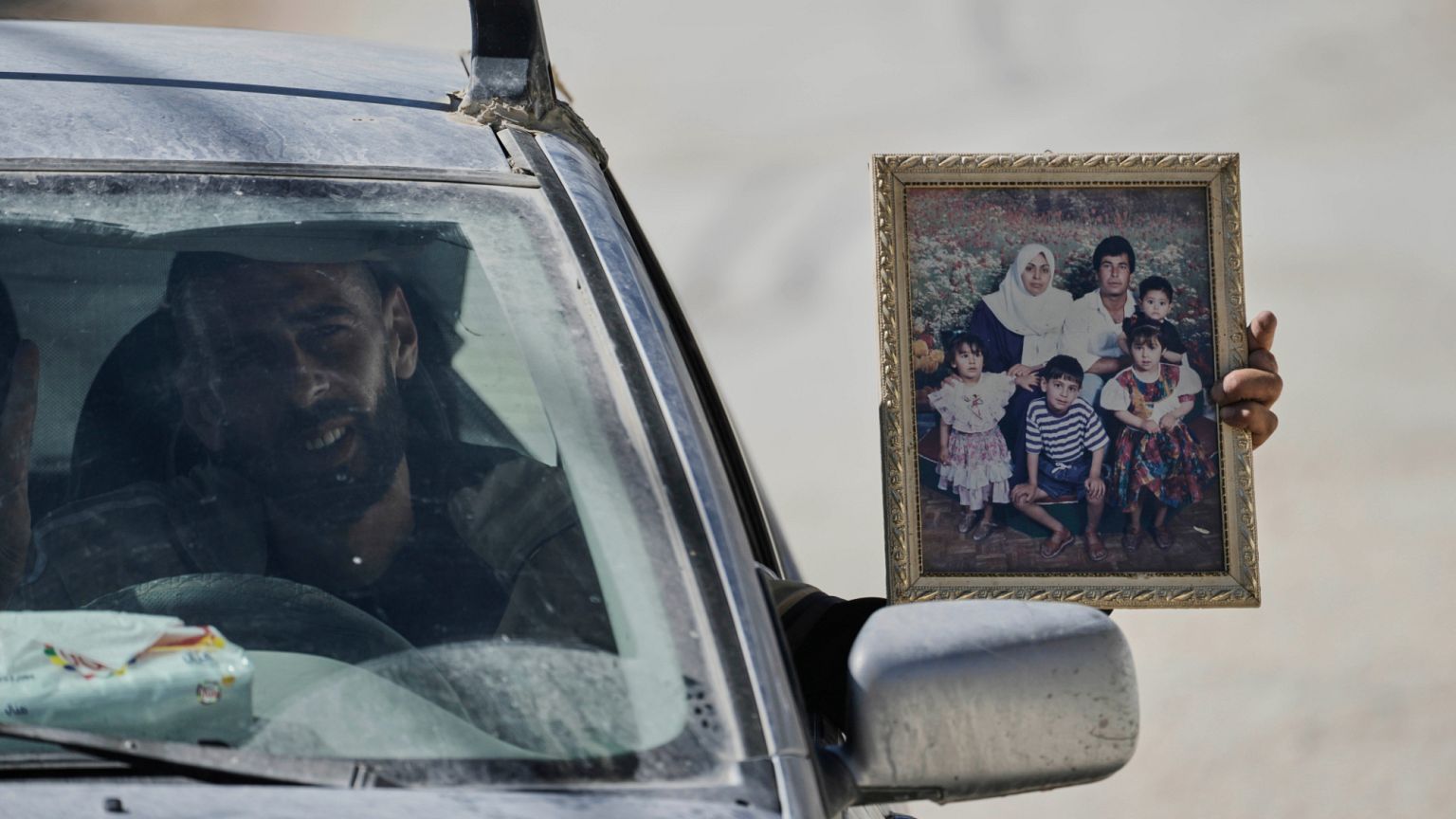 Palestinian resident of the West Bank refugee camp of Nur Shams carries his family photo while evacuates his home ahead of planned demolitions by Israeli security, 06.05.2025