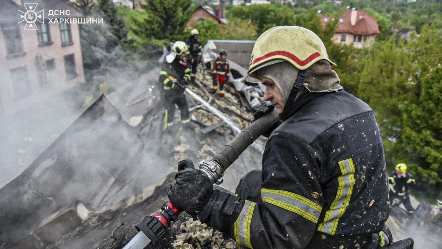 Rescue workers extinguish a fire in a building which was heavily damaged by a Russian strike on Kharkiv, 6 May, 2025 