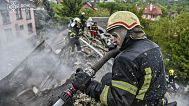 Rescue workers extinguish a fire in a building which was heavily damaged by a Russian strike on Kharkiv, 6 May, 2025 