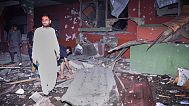 Local residents examine a building damaged from a suspected Indian missile attack near Muzaffarabad, the capital of Pakistan controlled Kashmir, in Wednesday, May 7, 2025