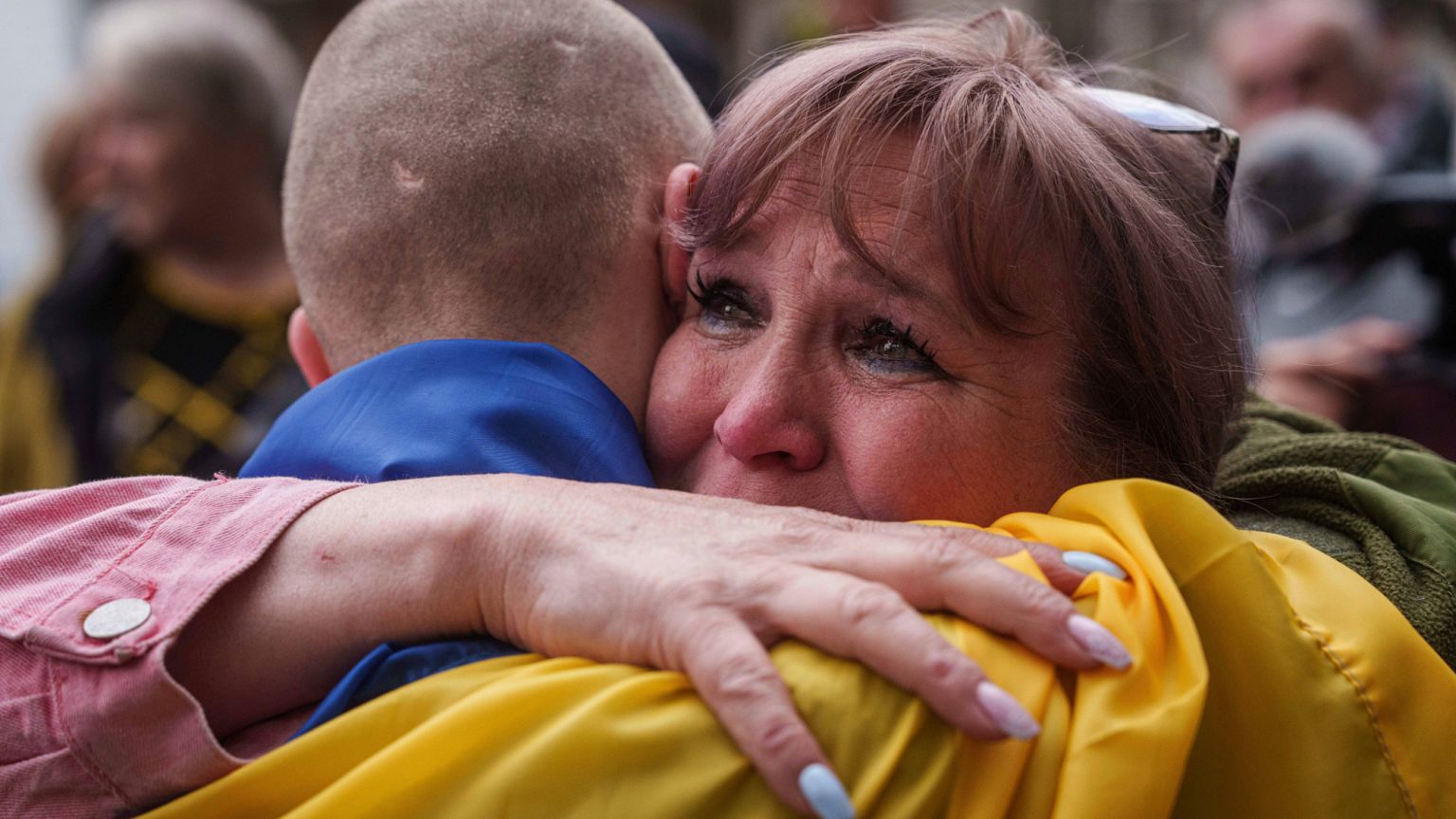 A Ukrainian soldier hugs a woman after returning from captivity in a POW exchange in Ukraine, Tuesday, May 6, 2025.