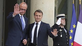 French President Emmanuel Macron, center, welcomes German Chancellor Friedrich Merz Wednesday, May 7, 2025 at the Elysee Palace in Paris.