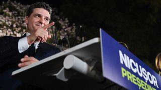 Presidential candidate Nicusor Dan gestures as he addresses supporters after polls closed for the first round of the country's presidential election redo in Bucharest.