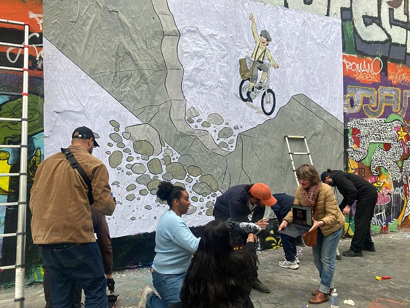 Street art contributors show the collage to the original Mexican artist Guffo