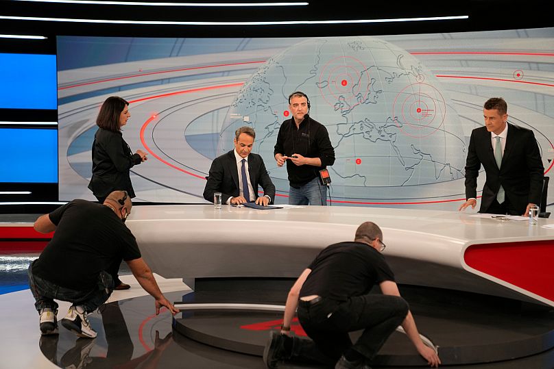 Technicians prepare a studio before an interview with Greece's Prime Minister Kyriakos Mitsotakis at Alpha television station in Athens, 25 April, 2023