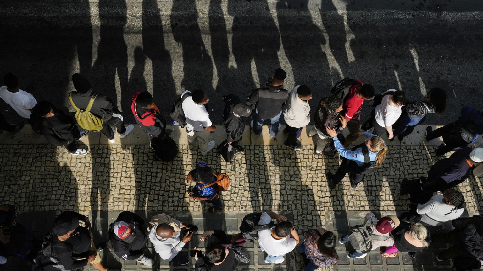 Passengers queue at Oriente transportation hub during a nationwide power outage in Lisbon, Monday, April 28, 2025.