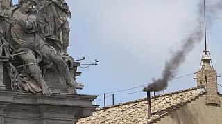 Black smoke billows from the chimney of the Sistine Chapel during the conclave to elect a successor of late Pope Francis, at the Vatican, Thursday, May 8, 2025.