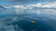A boat rides through a frozen sea inlet outside of Nuuk, Greenland, 6 March 2025.