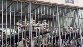 Prisoners look out of their cell in the Terrorist Confinement Center in Tecoluca, El Salvador, Wednesday, March 26, 2025. (AP Photo)