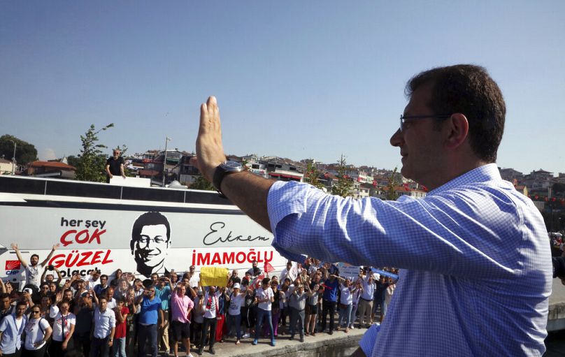 FILE: Ekrem Imamoglu, candidate of the Republican People's Party (CHP) salutes cheering supporters at the end of his last election rally in Istanbul, June 2019