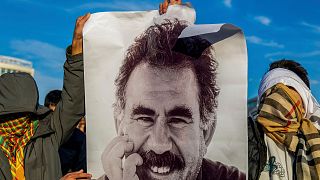 FILE - Youngsters hold a photograph of the jailed leader of the rebel Kurdistan Workers' Party, or PKK, Abdullah Ocalan, 27 Feb 2025.