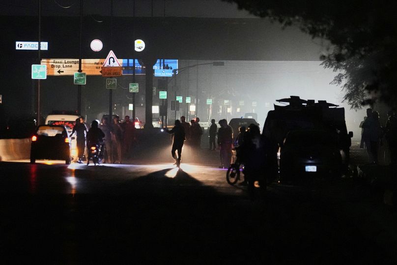Pakistani police officers remove vehicles and people from the main entry of Nur Khan airbase following an Indian missile strike in Rawalpindi, Pakistan, Saturday, May 10, 2025