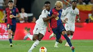 Barcelona's Lamine Yamal, right, fights for the ball with Real Madrid's Vinicius Junior during the Spanish Copa del Rey final, April 2025.