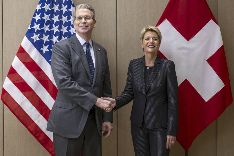 US Secretary of the Treasury Scott Bessent, left, shakes hands with Switzerland's President Karin Keller-Sutter, right,  in Geneva, Switzerland, on Friday, May 9, 2025.