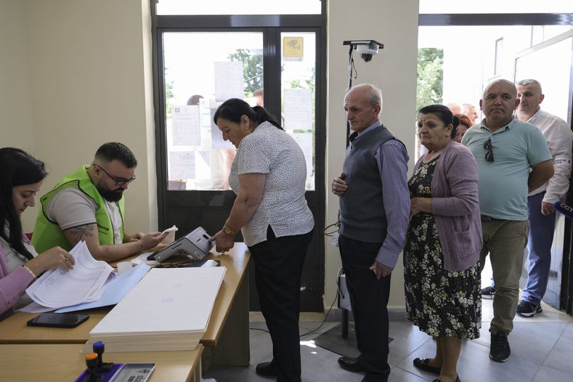 People line up at a voting station during a general election where Socialist Edi Rama is seeking a fourth term as Albania's prime minister in Tirana, Albania Sunday, May 11.