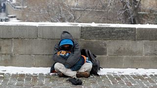 A man sits on the Charles Bridge in Prague, the Czech Republic, in December 2020.