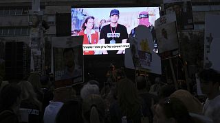 People gather in Tel Aviv to watch a live broadcast of Israeli-American soldier Edan Alexander being released by Hamas, 12 May, 2025