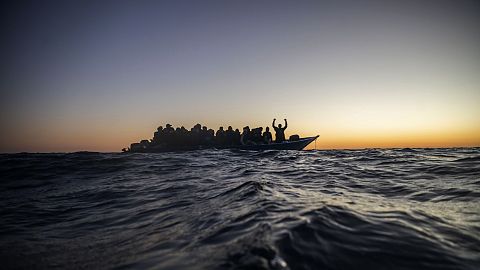 Migrants and refugees wait for assistance on an overcrowded wooden boat in the Mediterranean Sea, 12 February, 2021