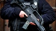 FILE: An armed police officer stands guard at the Houses of Parliament in London, 14 January 2016