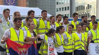 Students participating in the ultramarathon relay from Novi Sad, Serbia, arrive at their final destination, Brussels, Monday, May 12, 2025