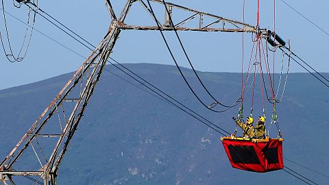 Technicians work on high voltage lines above the town of Ascain in south west France. 
