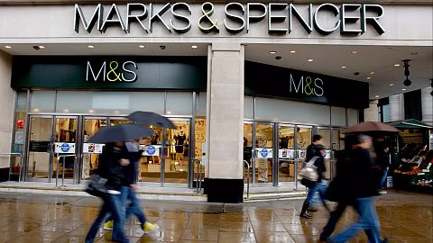 Pedestrians pass a branch of Marks and Spencer at Marble Arch in London, Tuesday, May 19, 2009.