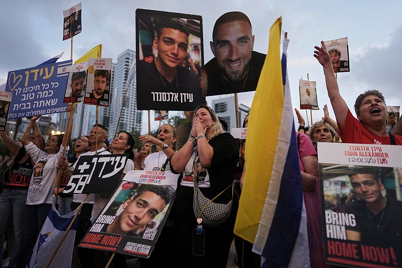 People watch a live broadcast of Israeli-US soldier Edan Alexander as he is released from Hamas captivity in Gaza, 12 May, 2025