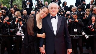 Robert De Niro and Tiffany Chen pose for photographers during the opening ceremony red carpet of the 78th international film festival, Cannes, France, Tuesday, May 13, 2025