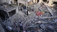 Palestinians inspect the rubble of homes destroyed by Israeli airstrikes in Jabalia, northern Gaza Strip, 14 May 2025